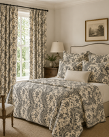 A styled bedroom featuring a bed dressed in a beige and gray floral toile patterned comforter set, matching pillows, and coordinating curtains hanging by a window. Callista Home Torrent 72C black and white geometric French linen fabric by Antoinette Poisson , Callista Home