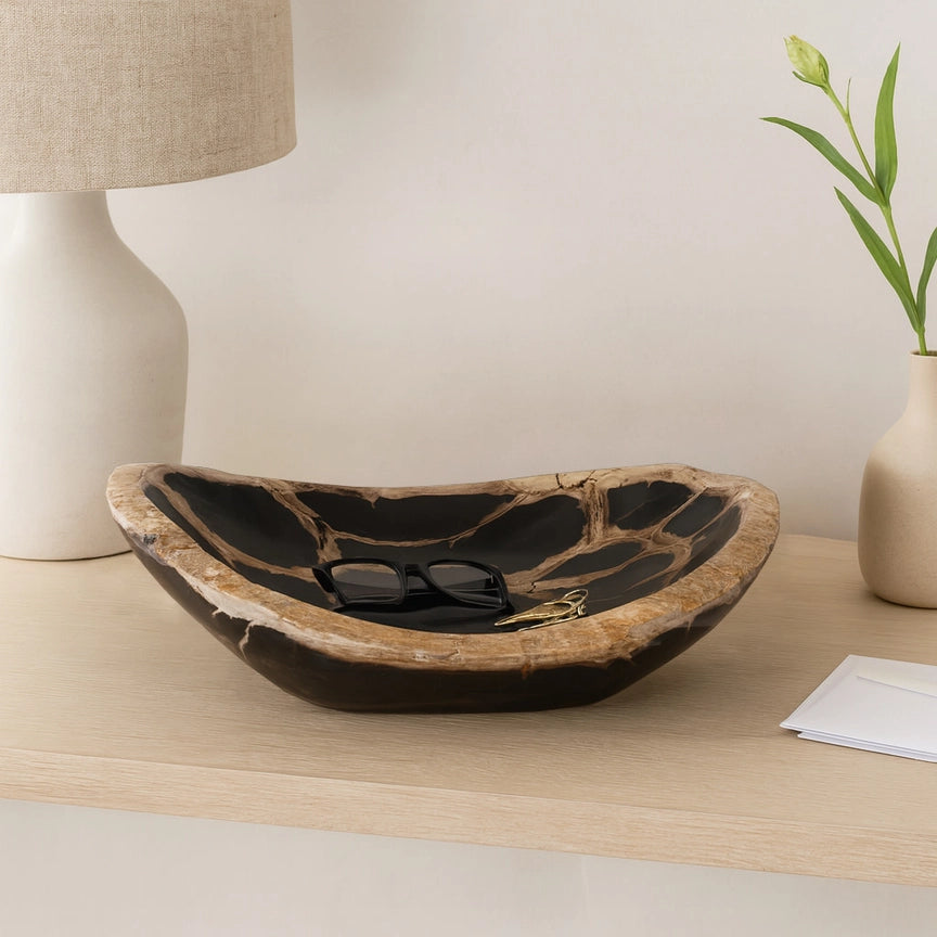Decorative bowl on a wooden surface with a lamp and plant in the background Callista Home