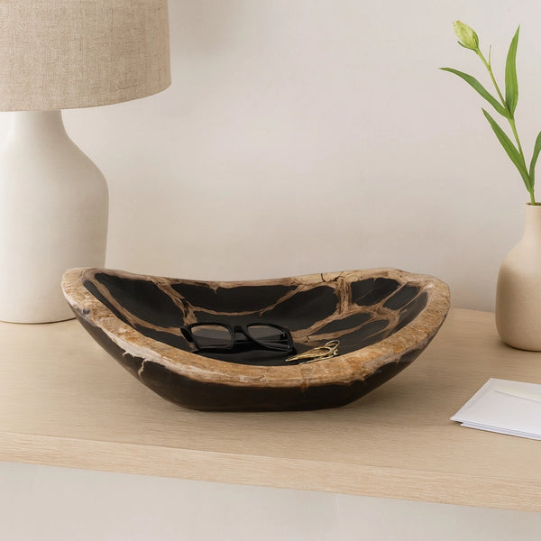 Decorative bowl on a wooden surface with a lamp and plant in the background Callista Home