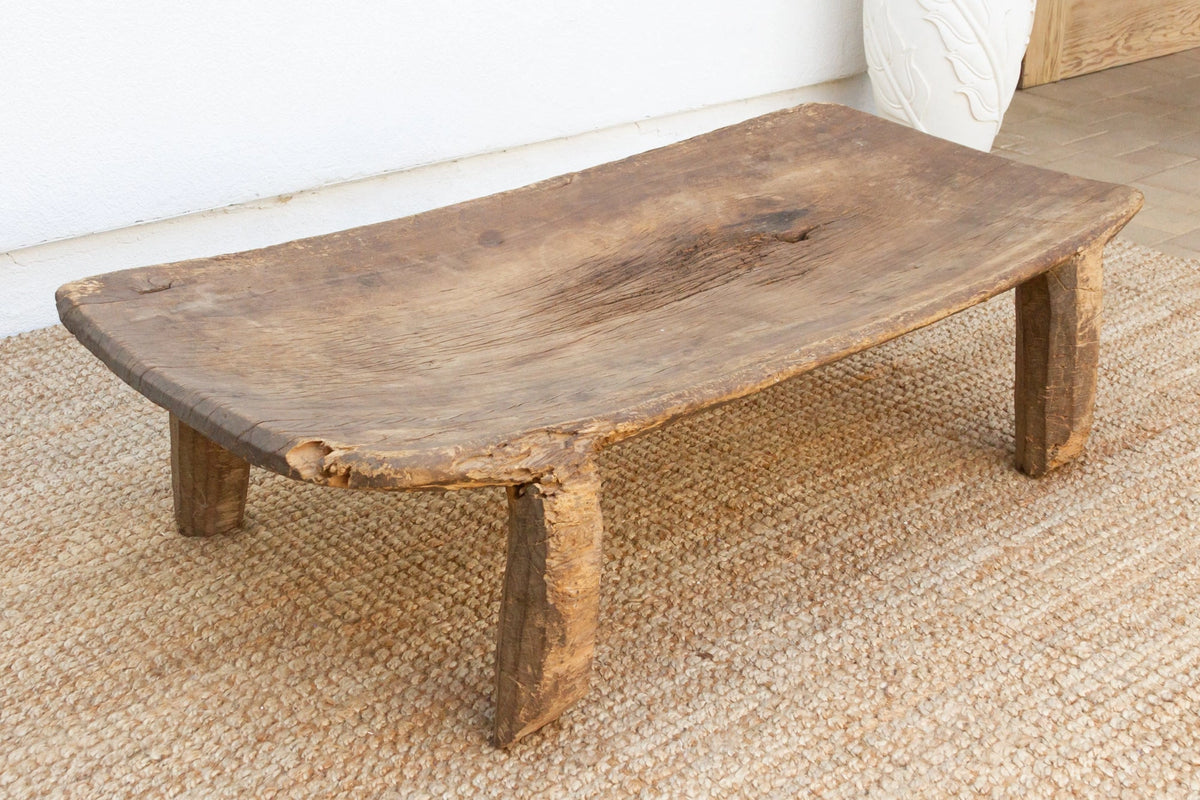 Rustic wooden coffee table on a textured floor