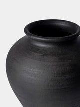 Black ceramic jar on a white background