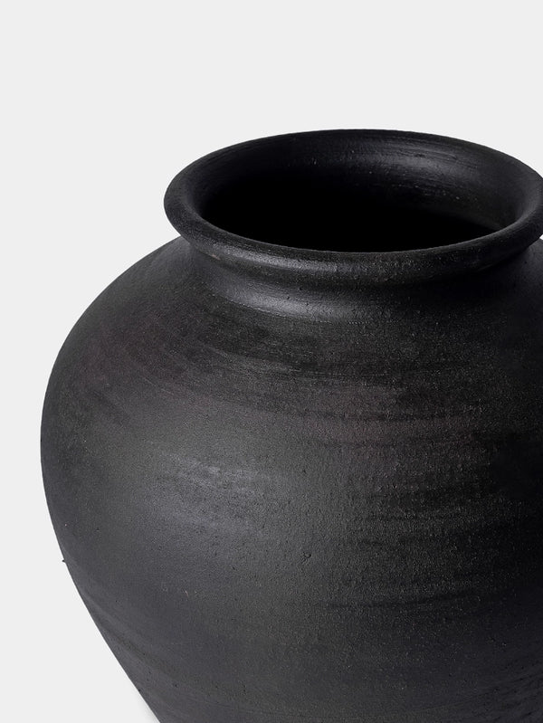 Black ceramic jar on a white background