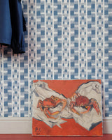 Wallpaper with geometric pattern and a painting of crabs on an orange background.