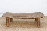 Wooden bench on a textured surface with a white background