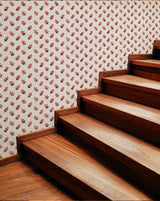 Wooden staircase with floral wallpaper in the background