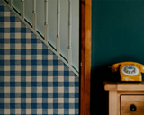 Carreaux Indigo 84A geometric French wallpaper by Antoinette Poisson featuring an elegant indigo checkered pattern inspired by 18th-century domino papers.