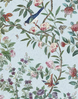 A botanical pattern fabric featuring green leaves, pink and red flowers, birds, butterflies, and ladybugs on a pale blue background. Callista Home