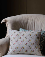 Decorative pillow with bird pattern on a sofa Baies 56A botanical berry French linen fabric by Antoinette Poisson Callista Home