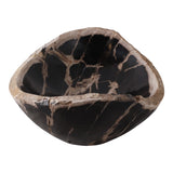 A rustic hand-carved stone bowl made from black basalt with natural beige and brown veining, shown on a solid white background. Callista Home