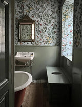 Bathroom with floral wallpaper, sink, and toilet. Chinois Canton Wallpaper Panel 70C by Antoinette Poisson featuring birds, butterflies, and flowering branches inspired by authentic 18th-century Chinese wall coverings. Callista Home
