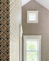 Patterned wallpaper with a geometric design in a room with windows.