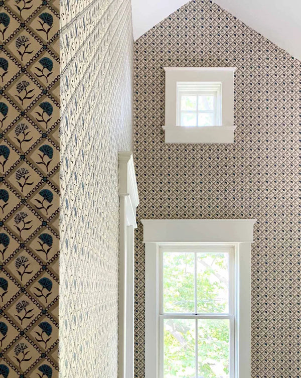 Patterned wallpaper with a geometric design in a room with windows.