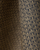 Close-up of a woven fabric with a repeating geometric basketweave pattern in beige and dark navy blue. Osier 18A geometric French linen fabric by Antoinette Poisson allista Home