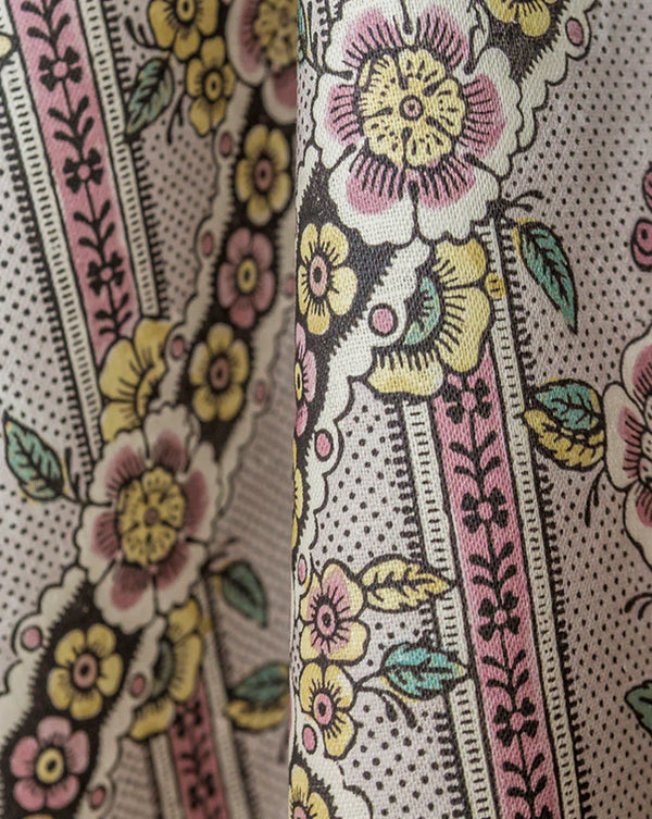 Close-up of floral patterned fabric with pink, yellow, and green colors. Callista Home